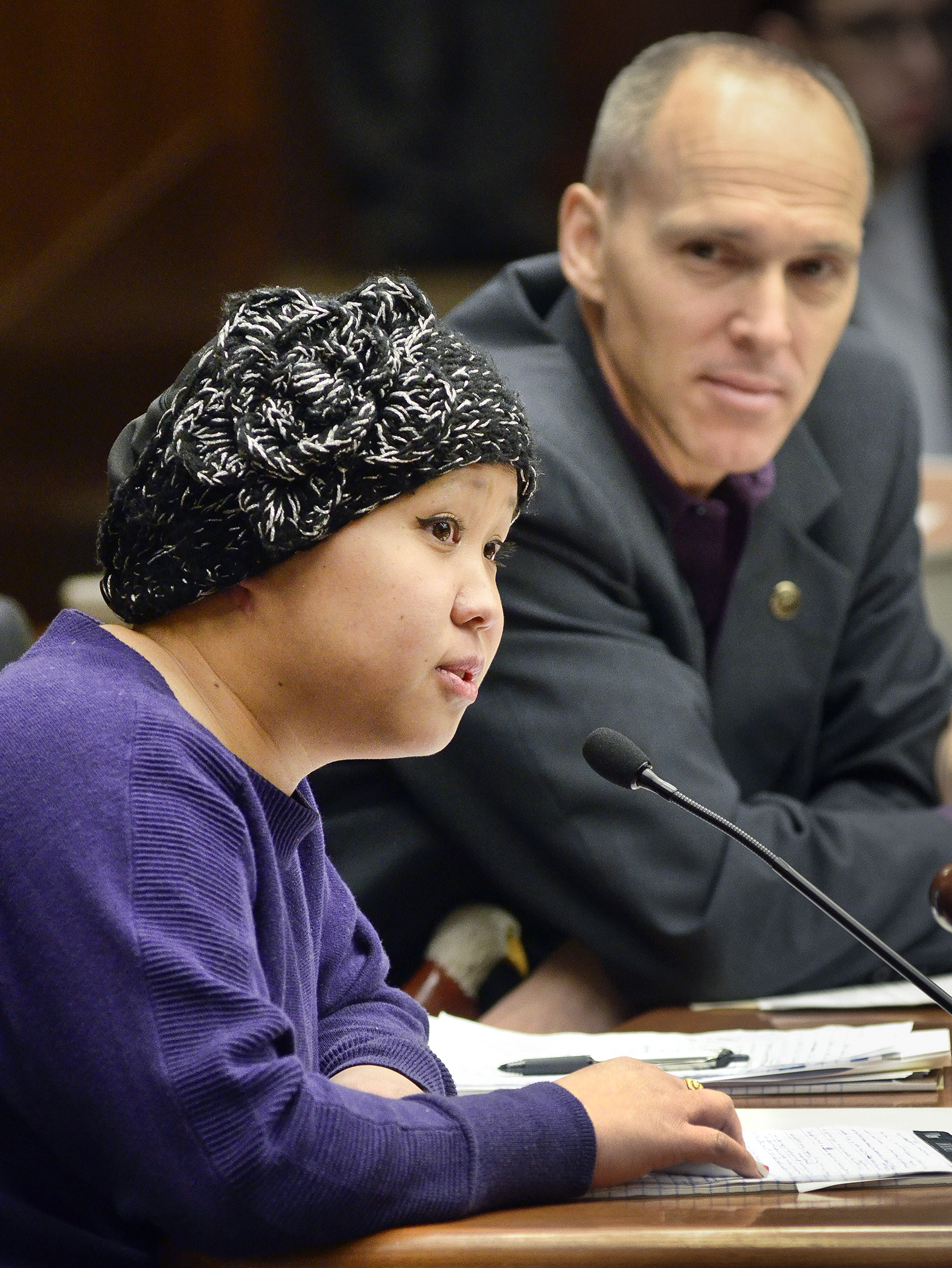 Sinying Lee of St. Paul testifies before the House Education Innovation Policy Committee March 26 in support of a bill sponsored by Rep. Rod Hamilton, right, that would provide a Hmong and Southeast Asian children and family program. Photo by Andrew VonBank